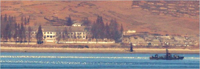 A North Korean navy ship off a North Korean village on Friday, seen from South Korea.